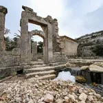 Water flows through the ruins at the site of the ancient Greco-Roman city of Cyrene (Shahhat) in eastern Libya, about 60 kilometres (37 miles) west of Derna, on September 21,2023, in the aftermath of a devastating flood. The immediate damage to the monuments of Cyrene, which include the second century AD Temple of Zeus, bigger than the Parthenon in Athens, is relatively minor but the water circulating around their foundations threatens future collapses, the head of the French archaeological mission in Libya, Vincent Michel, told AFP. (Photo by Ozan KOSE / AFP) (Photo by OZAN KOSE/AFP via Getty Images)