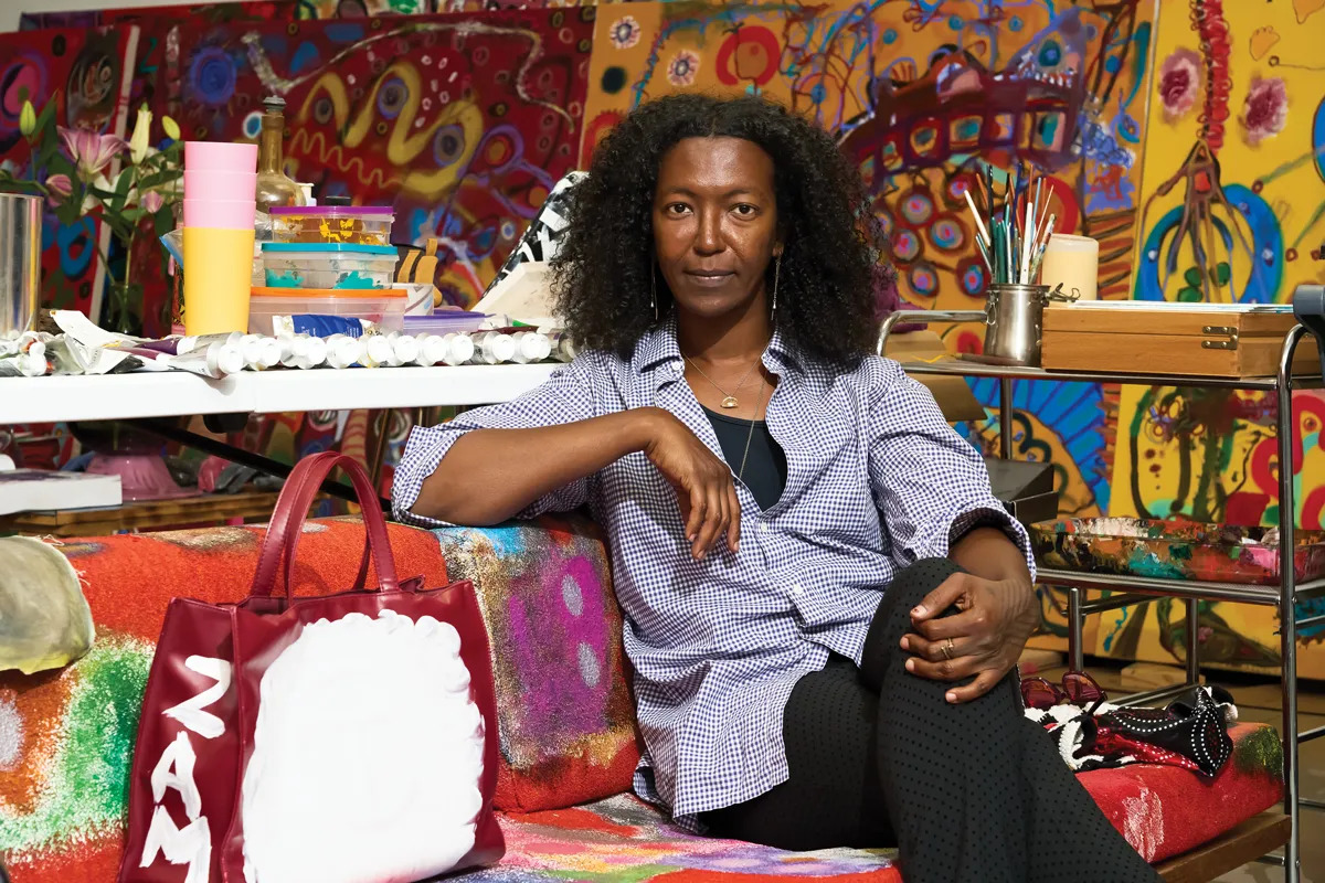 Uman sits on a couch in her studio in Albany, New York.