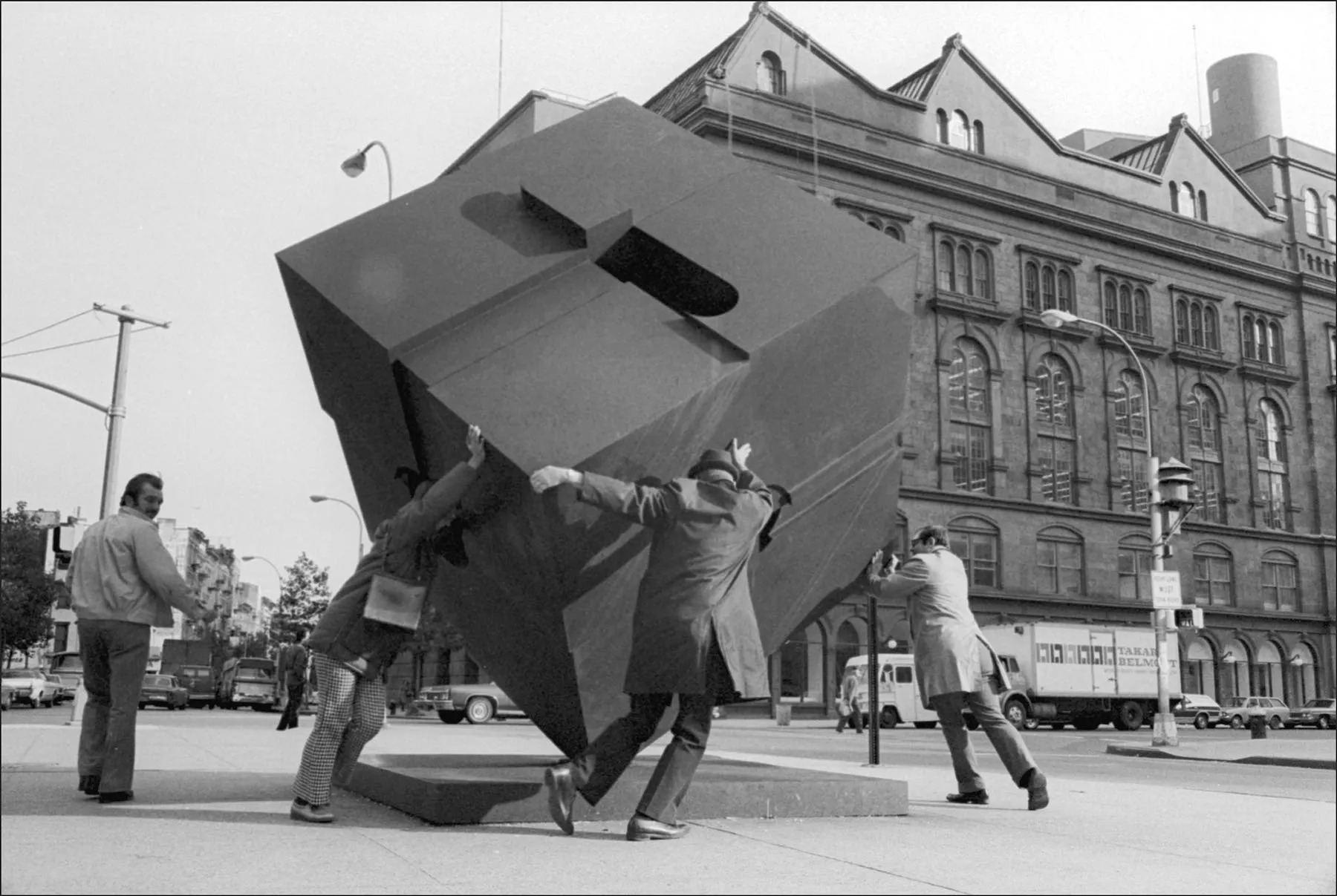 Passers-by rotate Tony Rosenthal’s Alamo (1967) in Cooper Square, New York City, October 10, 1974.