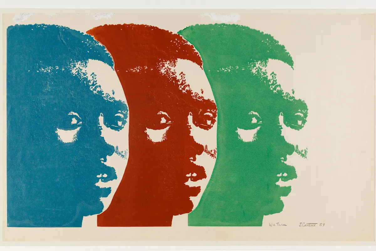 A print showing the head of a Black woman printed three times. Her head is shown in blue, red, and green. The heads are somewhat layered over one another.