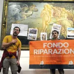 Protesters from the action group Last Generation stick a sign and photographs of floods on the glass covering Sandro Botticelli
