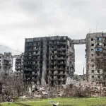 MARIUPOL, UKRAINE - 2022/04/16: Residential buildings are damaged by fire and hollowed out by airstrikes in Mariupol. The battle between Russian / Pro Russian forces and the defending Ukrainian forces lead by the Azov battalion continues in the port city of Mariupol. (Photo by Maximilian Clarke/SOPA Images/LightRocket via Getty Images)