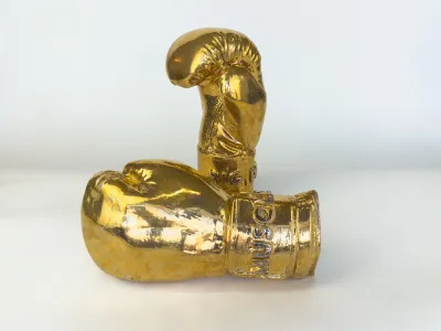A sculpture depicting golden boxing gloves.