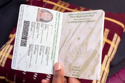 A photo showing a passport booklet for a Black woman. The passport has been issued by 