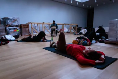 People lie down on mats during a dreaming workshop. 