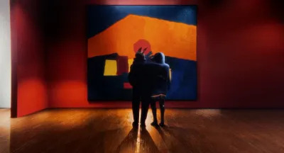 A jackal and a person standing before an abstract painting hanging in a museum.