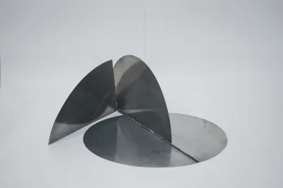 A folding sculpture composed of three metal semi-circles.