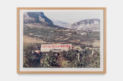 A mountainside with a large sign reading 