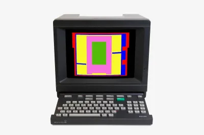 A computer with a keyboard whose screen displays an abstract geometric pattern.