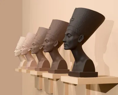 Five busts of a Pharaoh, each in differing skin tones, arranged from lightest to darkest.