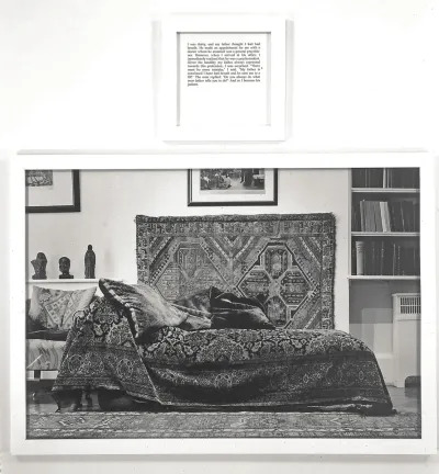 A black and white photograph of a bed with a text above it.