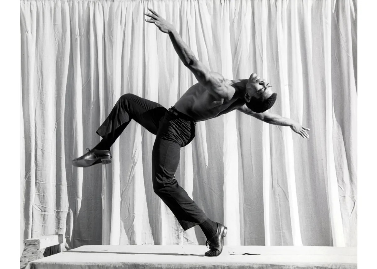 Portrait of Alvin Ailey in mid dance.