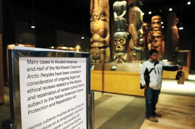 Messages for the public greet people upon arrival in the Halls of the Ancient Americas and the Hall of Northwest Coast and Arctic Peoples at the Field Museum in Chicago on Jan. 18, 2024.  The decision to cover various items in display cases was made in response to new revisions to the Department of Interior