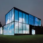 View of a projection of clouds on a glass building.