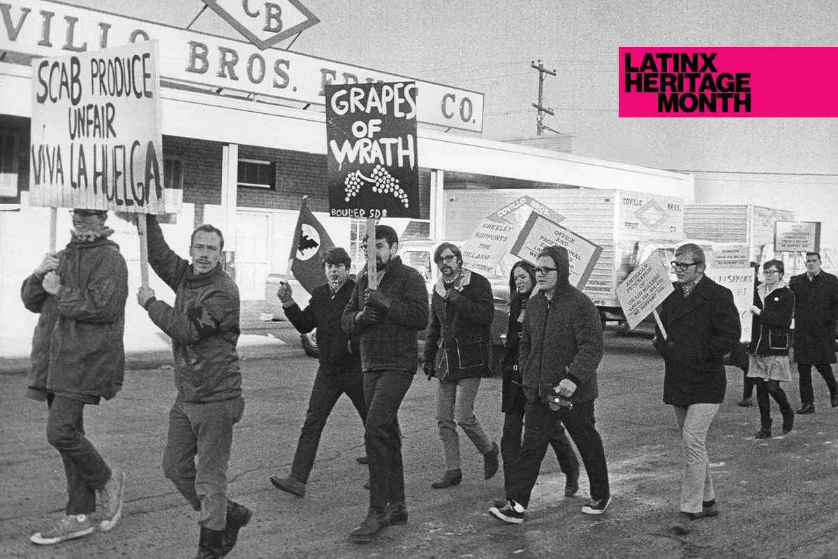 An archival photograph of a protest with people holding signs like 