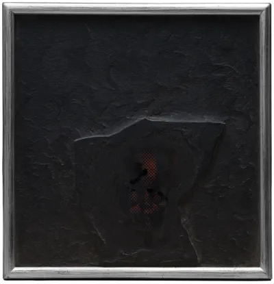 An all black painting with a raised figure emerging from it. 