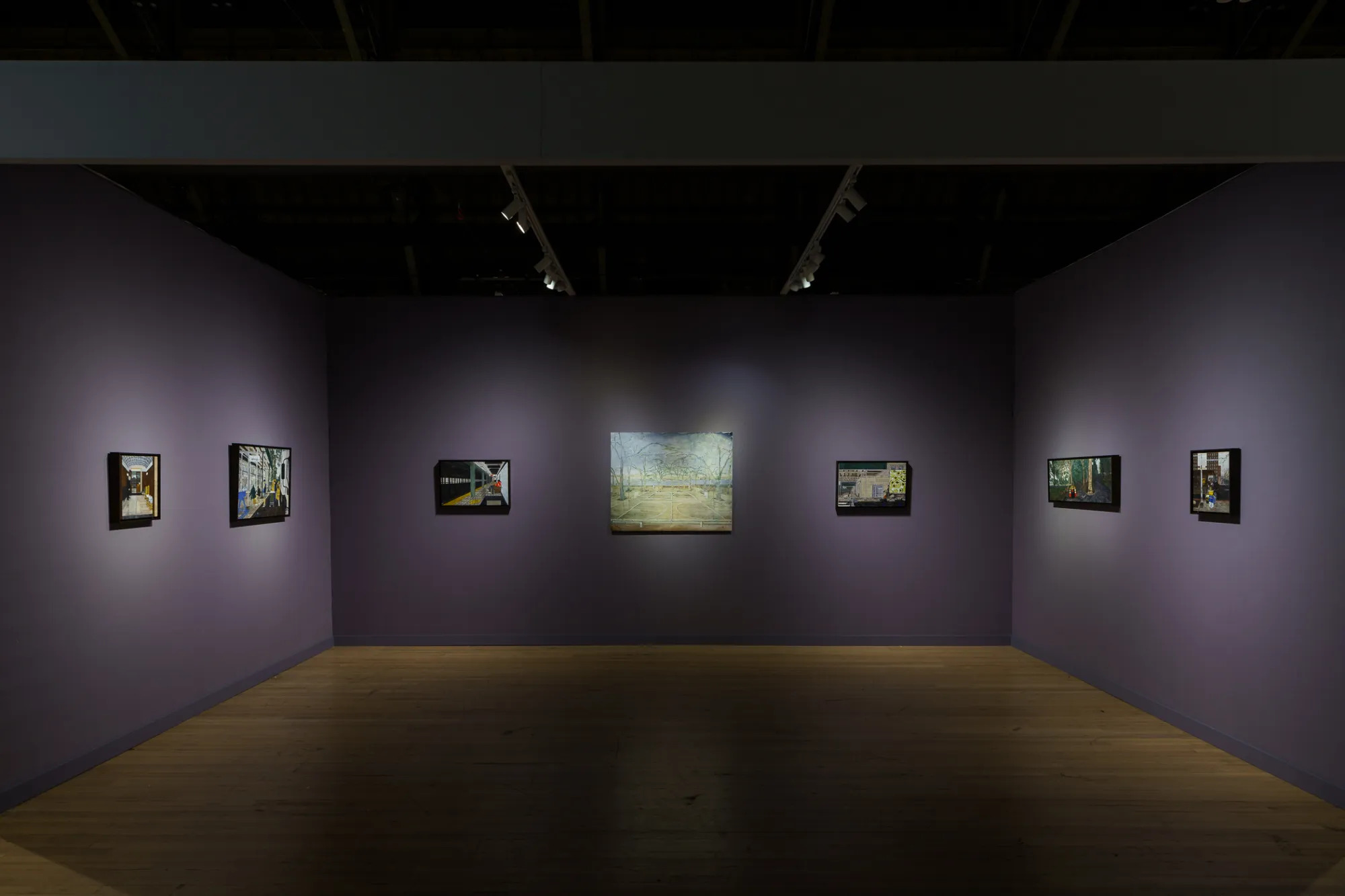 An art fair booth with purple walls and several paintings of New York City-scapes on the wall.