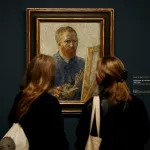 Visitors look at a selfportrait of Vincent Van Gogh at the Van Gogh Museum