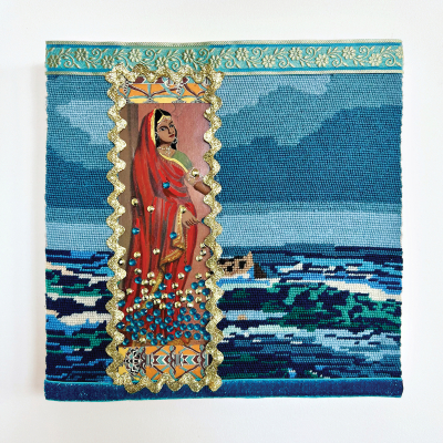 A mixed media work that uses a vintage needlepoint depicting the ocean and sky as its base. Layered over the needlepoint is an image of a standing dark-haired woman wearing a sari. Her lower half is covered in blue and gold rhinestones.