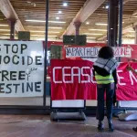 LONDON, UNITED KINGDOM - 2024/05/15: Students are seen putting on banners at the Central St Martin campus at the University of the Arts London (UAL). Students from the University of the Arts London (UAL) are seen rallying on their campus while the university holds a discussion with the Vice Chancellor about its stance on the Israel-Gaza war. Later, the students moved to the Central Saint Martins campus and began an encampment, vowing to continue until their demands are met by the university. Since late April, students from prestigious universities across the UK have been joining this new wave of occupation and encampment on their campuses, inspired by similar actions in the US, to urge their universities to adopt a pro-Palestinian stance on the Israel-Gaza war. (Photo by Hesther Ng/SOPA Images/LightRocket via Getty Images)