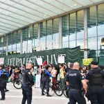 MIAMI BEACH, FLORIDA - DECEMBER 08: Protestors from the South Florida Coalition for Palestine demonstrate for a ceasefire in the Israel-Hamas conflict at Art Basel Miami Beach 2023 at the Miami Beach Convention Center on December 08, 2023 in Miami Beach, Florida. (Photo by Dave Benett/Jed Cullen/Dave Benett/Getty Images)