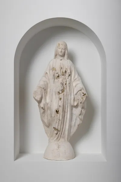 A plaster sculpture of the Virgen de Guadalupe. 