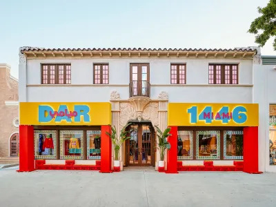 A retail shop that reads Dar Miami 1446 with yellow and red painted exterior. 