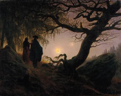 A man and a woman stand on a hill as the moon rises just above the craggly roots of an old tree.