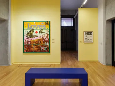 View of a museum exhibition showing a painting with 