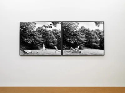 A photocollage showing a fornicating Black woman and white man floating above a field where Black children play below.