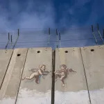 BETHLEHEM, WEST BANK - DECEMBER 23:  Evolution of Cherub Wall by Banksy is pictured on Israeli separation wall on December 23, 2023 in Bethlehem, West Bank. Last month, Christian Palestinian leaders here called off public Christmas celebrations, citing the effects of the ongoing war in Gaza. Regarded by Christians as the birthplace of Jesus, Bethlehem is usually bustling with foreign tourists this time of year, with streets full of holiday decoration and vendors selling ornaments and festive figurines. Israel