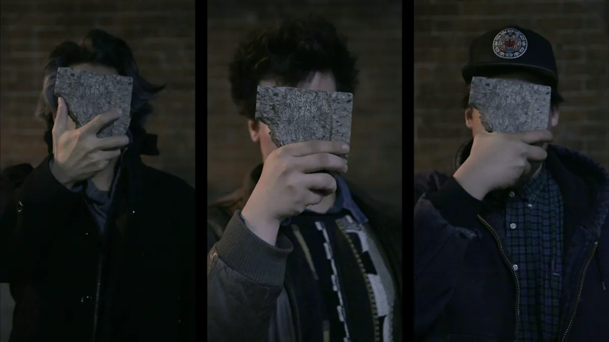 Composite image showing three men with pieces of stone covering their faces.