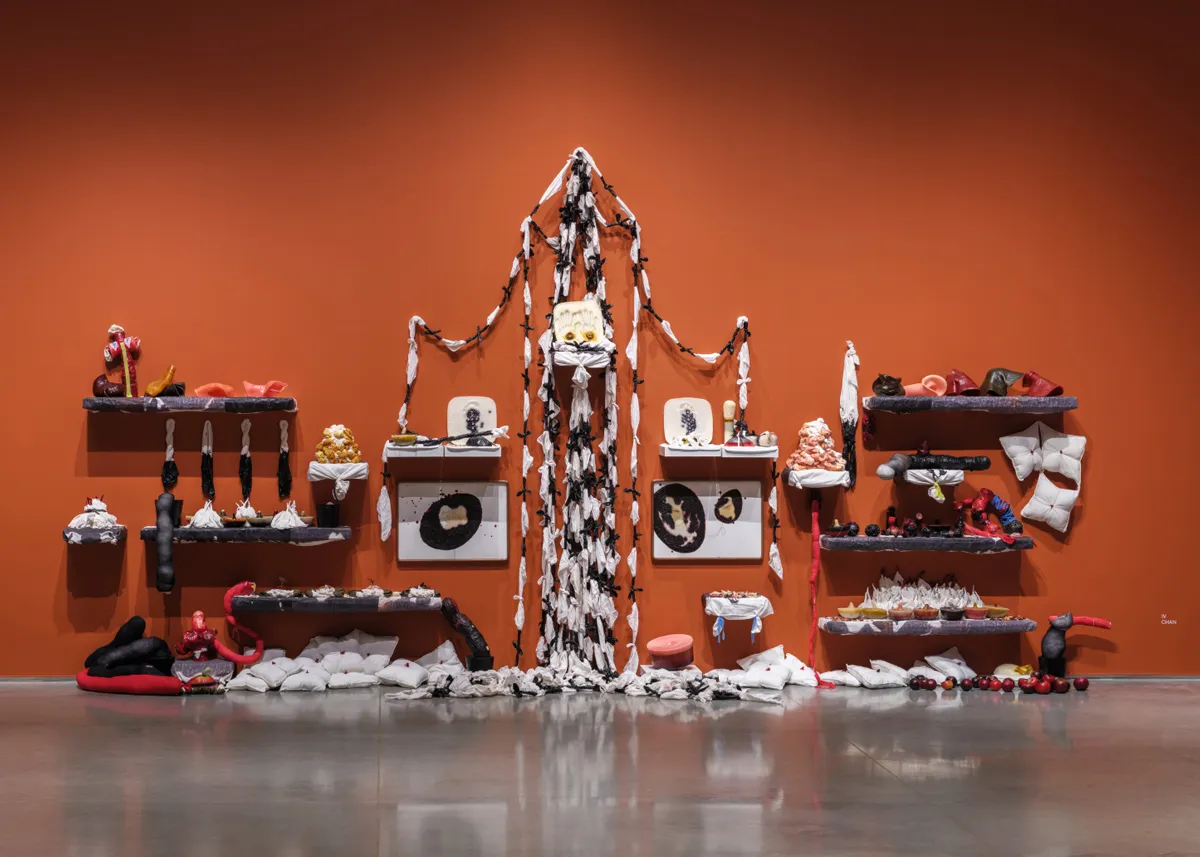 An installation featuring many parts and shelves that resembles an altar.