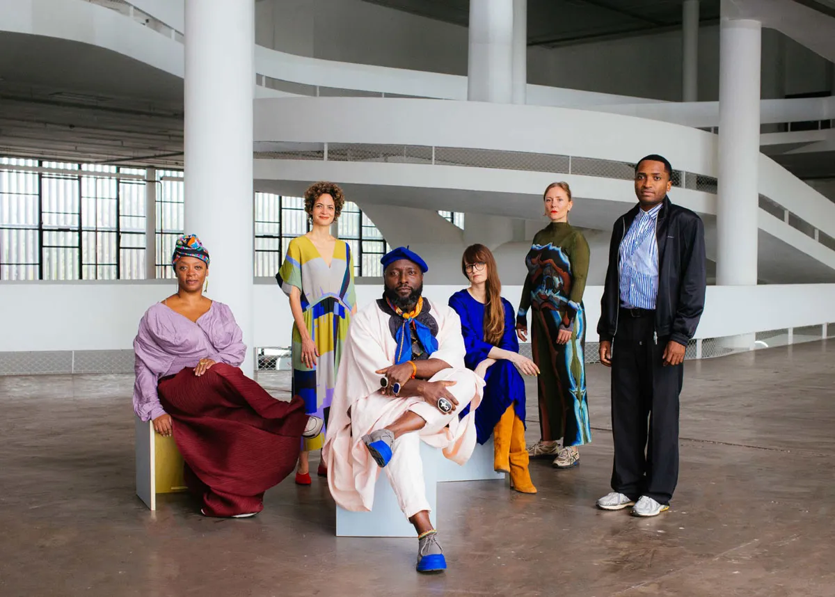 A portrait of six curators at the São Paulo Biennial Pavilion.