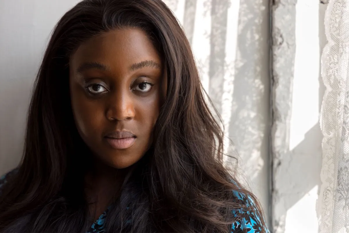 A Black woman in a blue shirt.